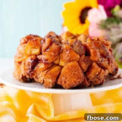 Close up photo of monkey bread on a white cake stand.