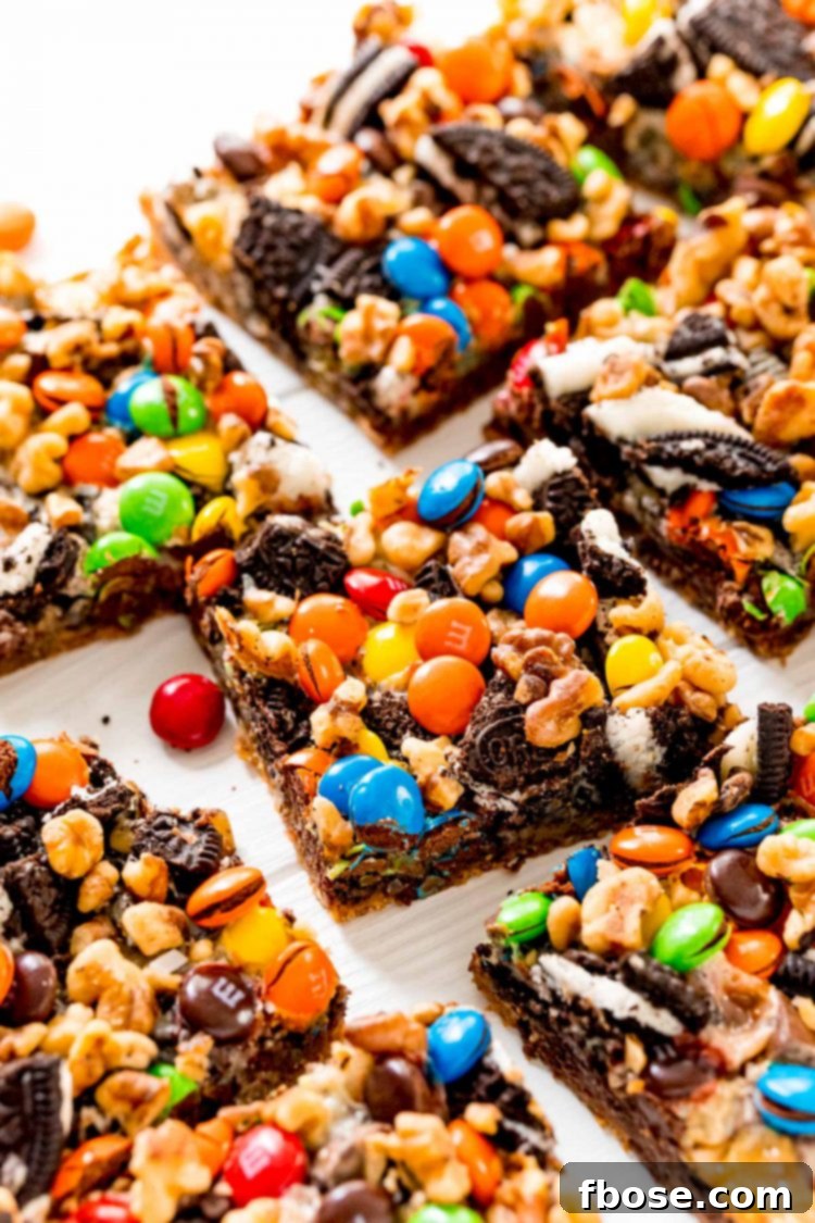 Close up photo of M&M 7 Layer Bars on a white table.