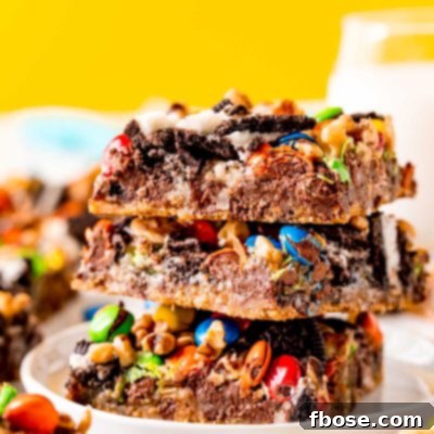 Close up photo of a stack of three oreo cookie bars on a white plate.
