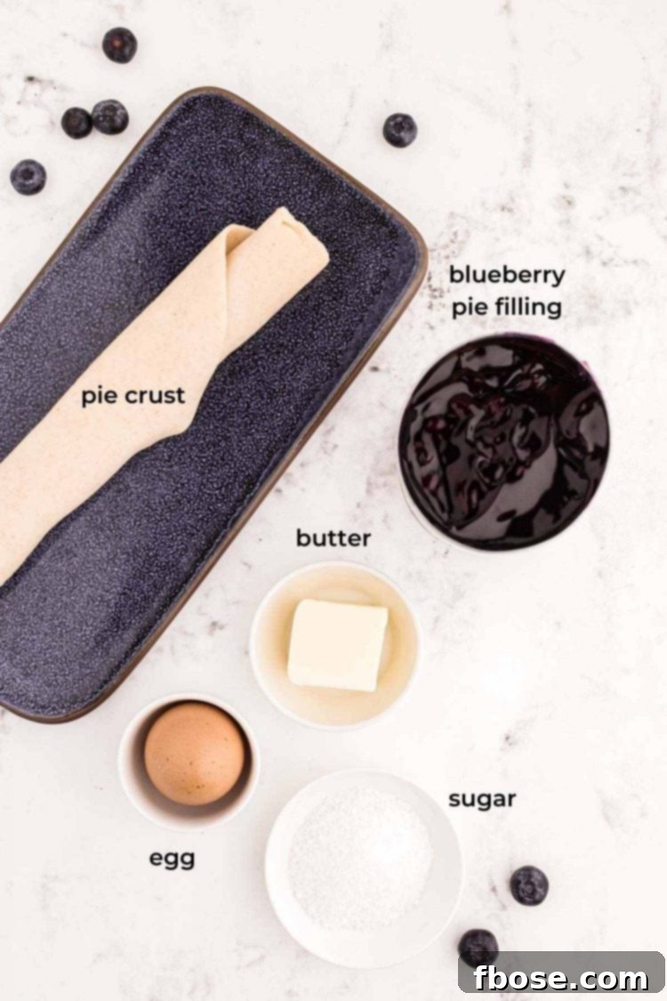 Ingredients to make blueberry hand pies on a marble counter.
