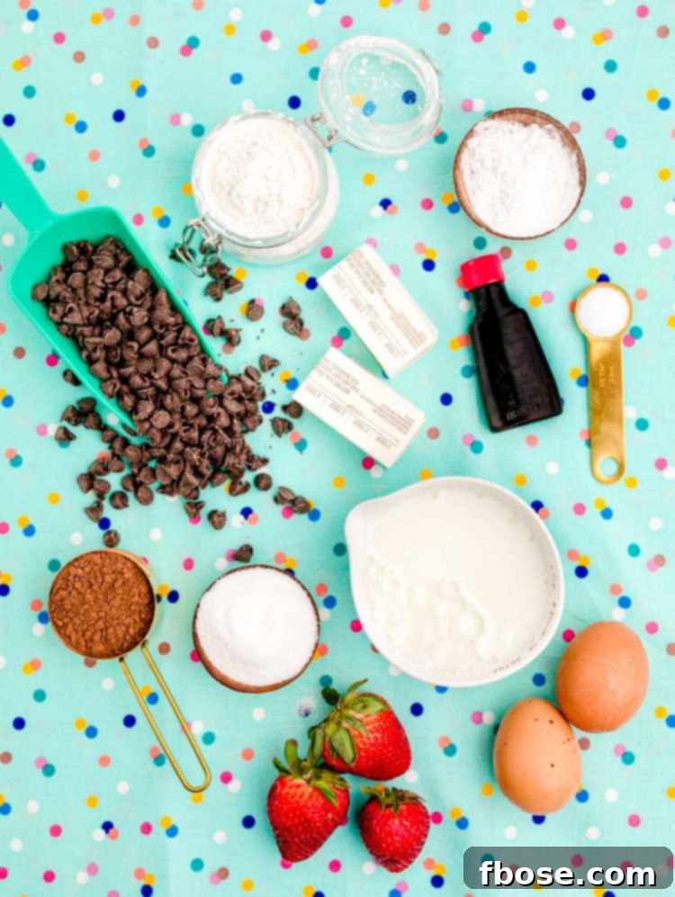Overhead photo of ingredients used to make chocolate waffles on a teal surface.