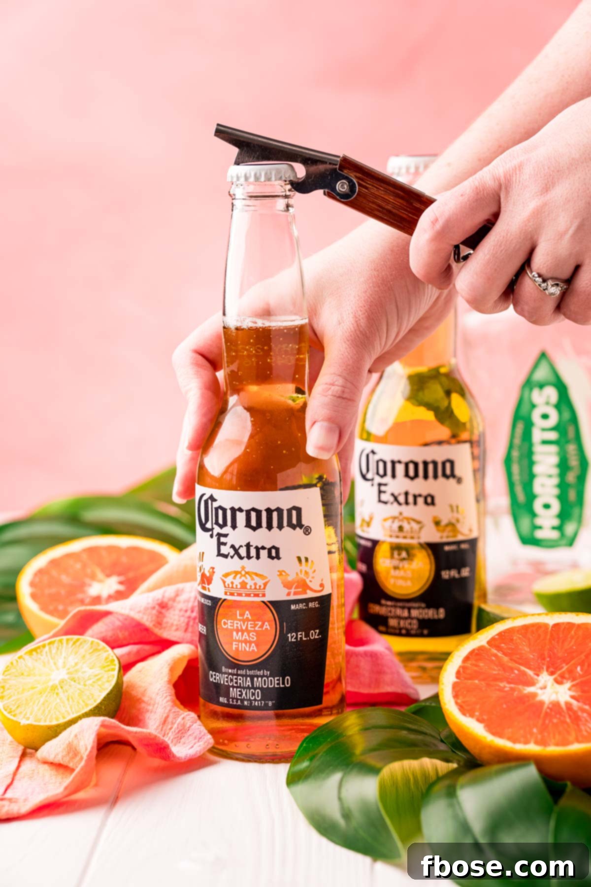 TikTok's Horizon Brew 3 A woman popping the cap of a Corona off with a bottle opener.