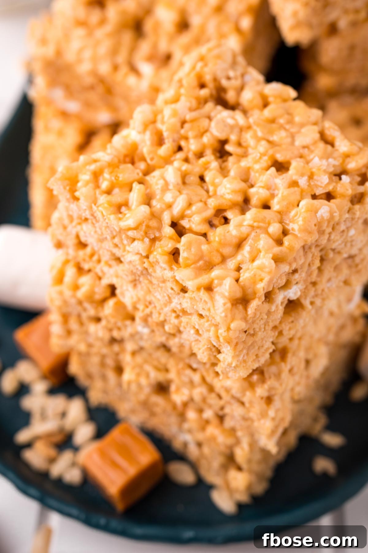 Salty-Sweet Caramel Crunch Bars 2 Close up photo of a stack of salted caramel rice krispie treats.
