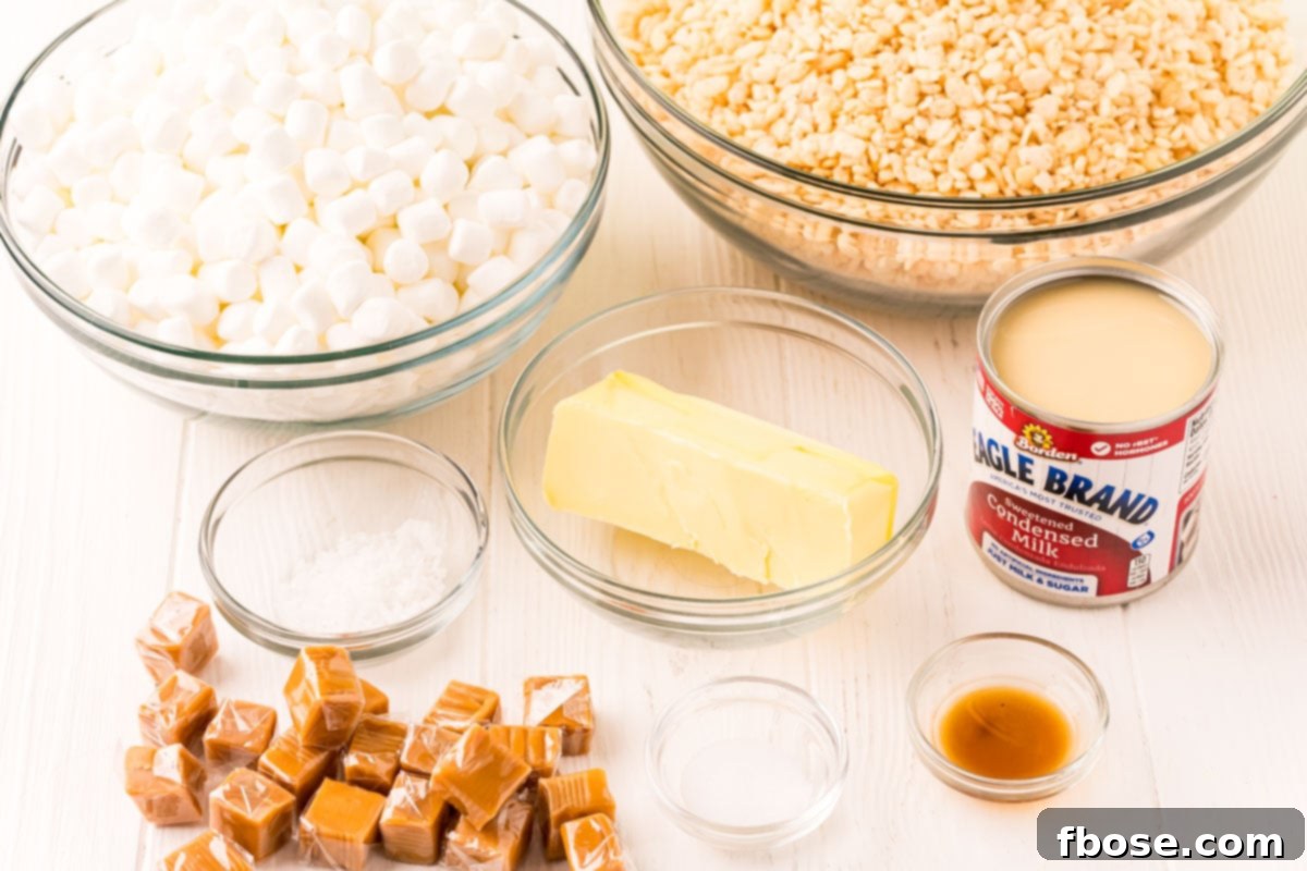 Salty-Sweet Caramel Crunch Bars 4 Ingredients to make salted caramel rice krispie treats on a white wood table.