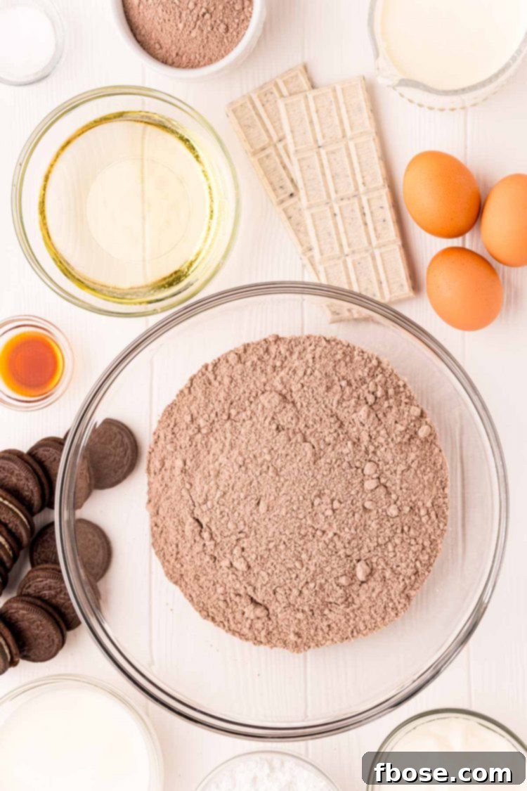 Ingredients to make Oreo Cupcakes displayed neatly on a white table.