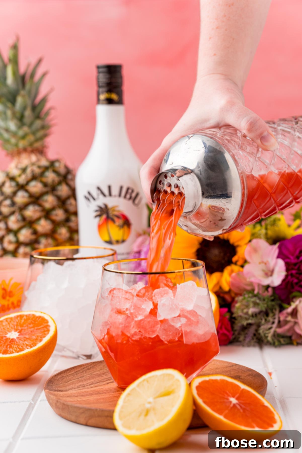 A bahama mama cocktail being strained into a glass.