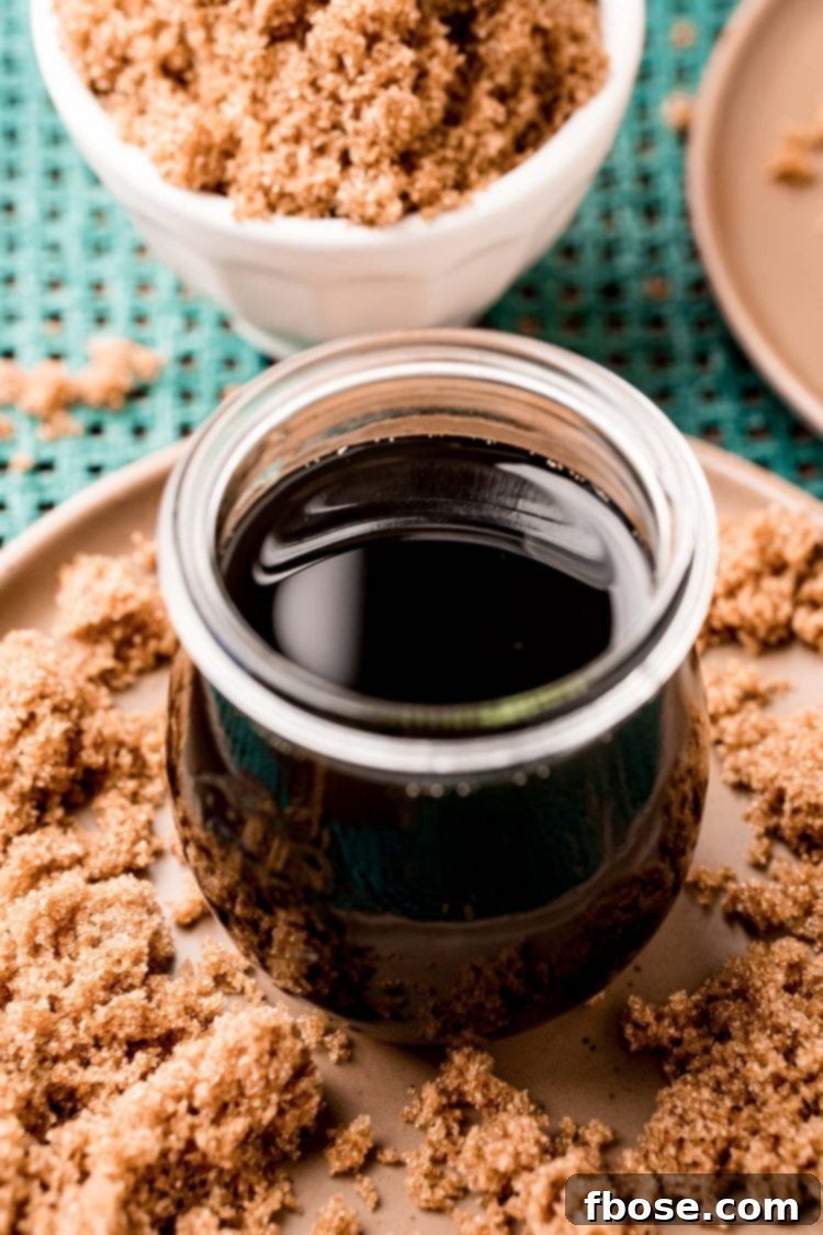 A close-up of a jar filled with shimmering brown sugar simple syrup, ready for use.