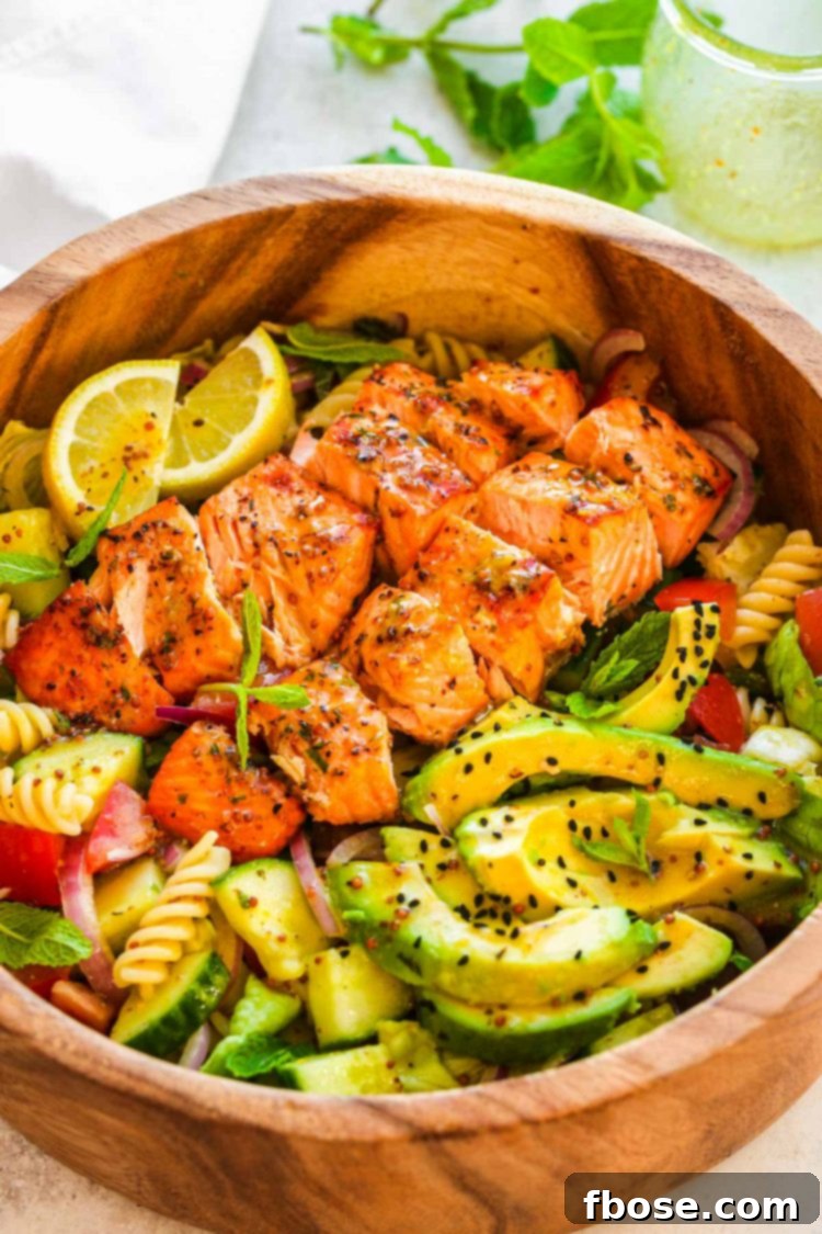 Salmon pasta salad in a wooden serving bowl.