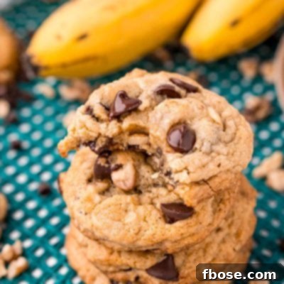 Ultimate Banana Bread Cookies 7 Close up photo of a stack of four banana bread cookies with the top one missing a bite.