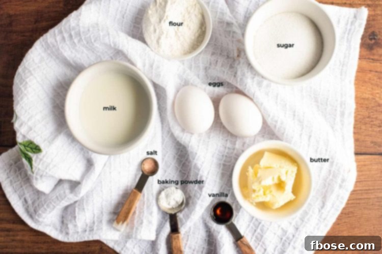Ingredients used to make donut cookies arranged on a white kitchen towel on a wooden table.