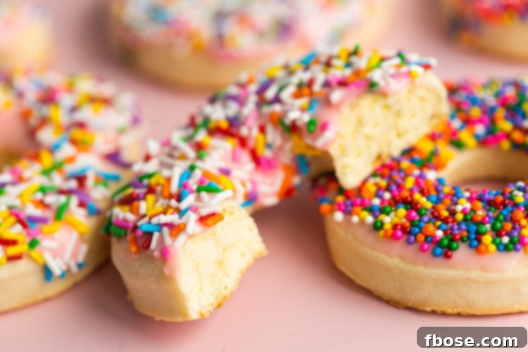 Close up photo of donut cookies with a bite taken out of it.