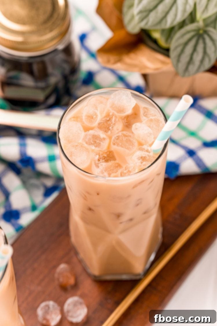 The Viral TikTok Starbucks Secret Cookie Butter Latte 6 Close up photo of a cookie butter latte in a glass with a blue and white napkin in the background.