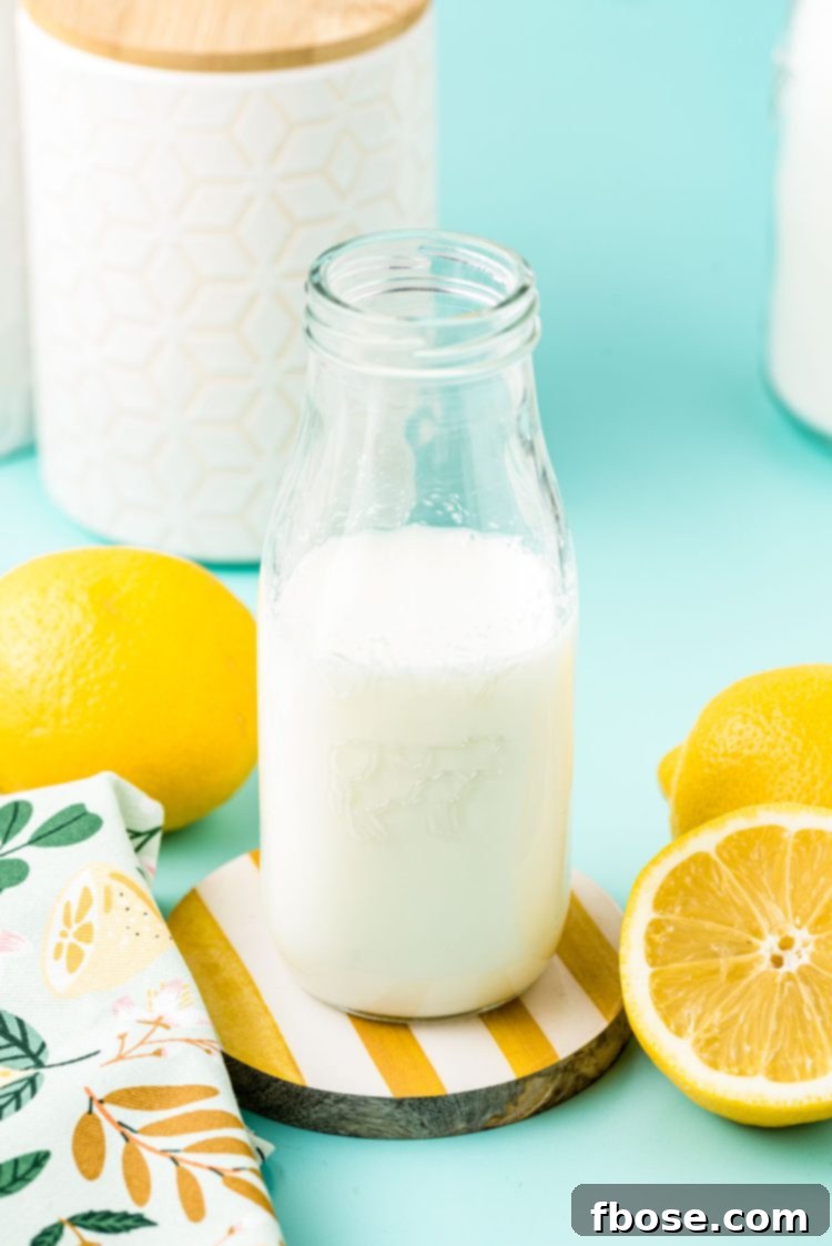 A glass milk bottle with buttermilk in it.