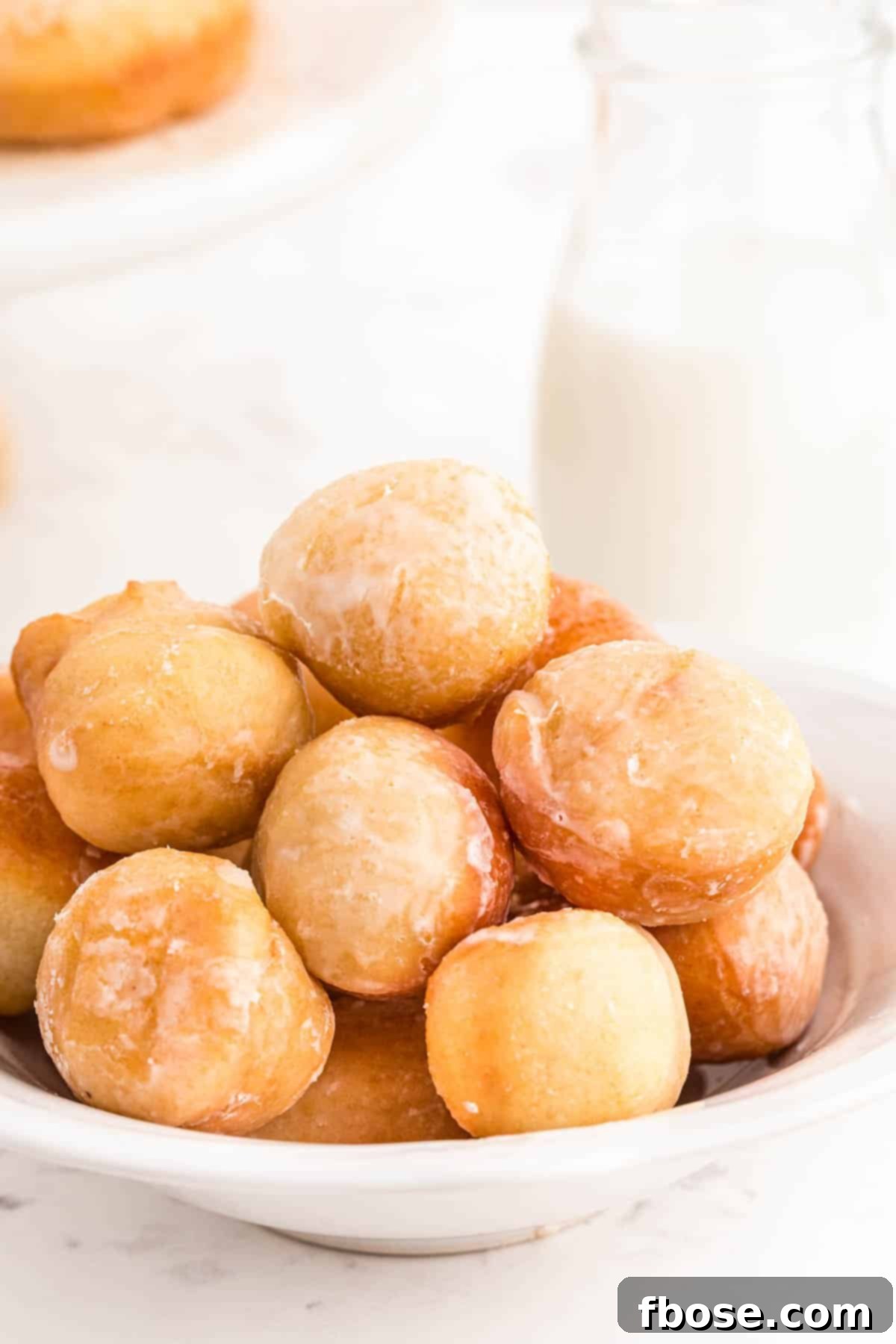 Sourdough donut holes in a white bowl.