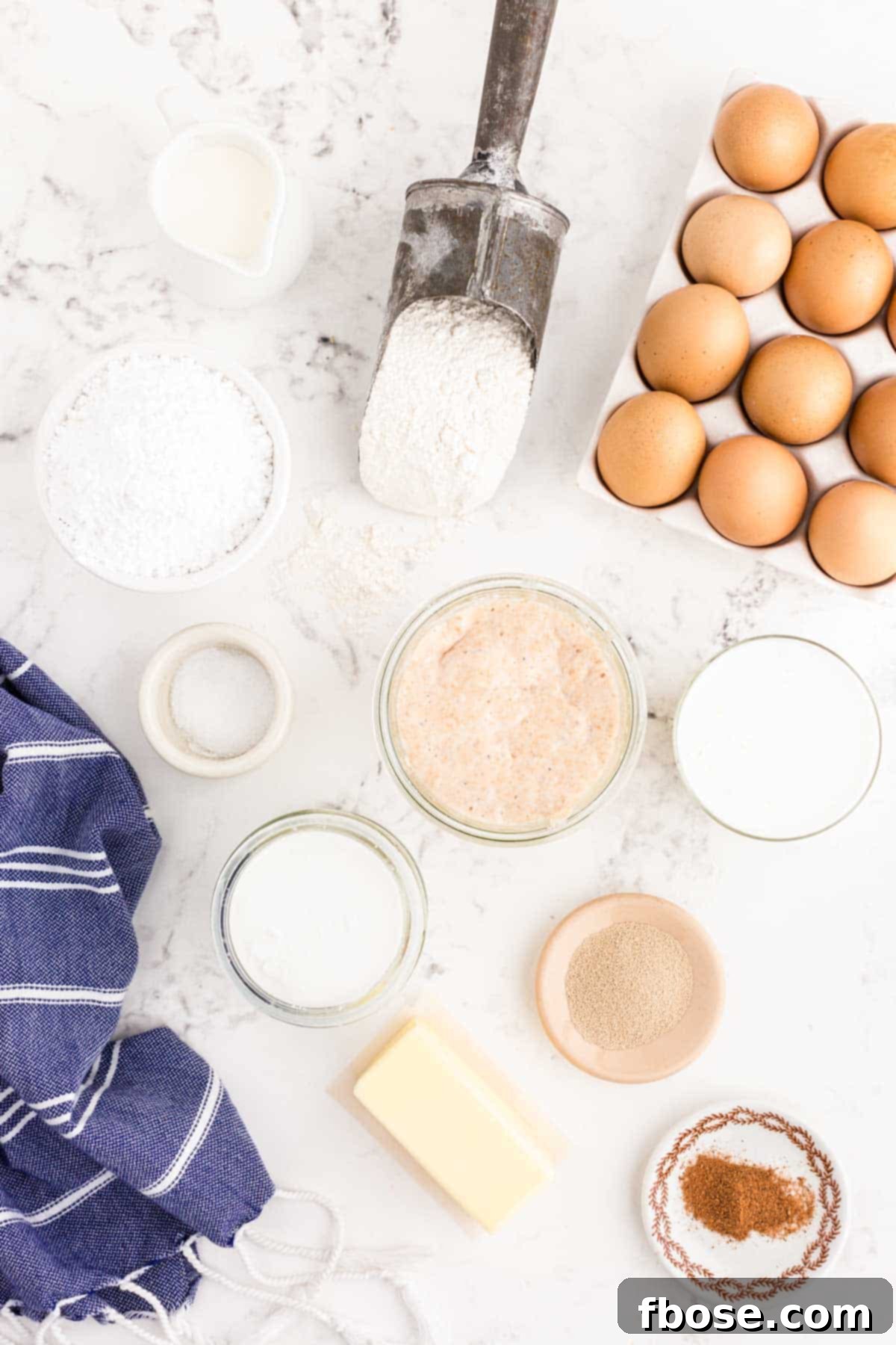 Ingredients to make sourdough donut holes on a white table.