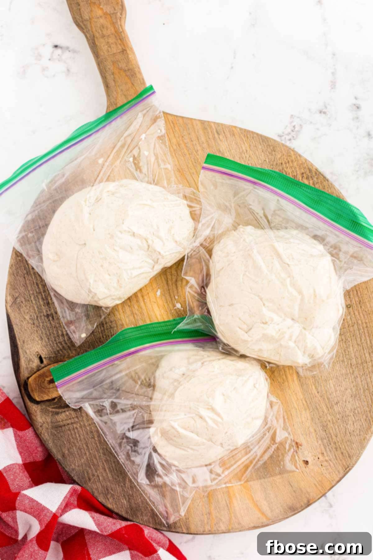 Perfect Sourdough Pizza Dough 13 Individual portions of sourdough pizza dough neatly divided and sealed in plastic bags, ready for refrigeration and cold proofing.