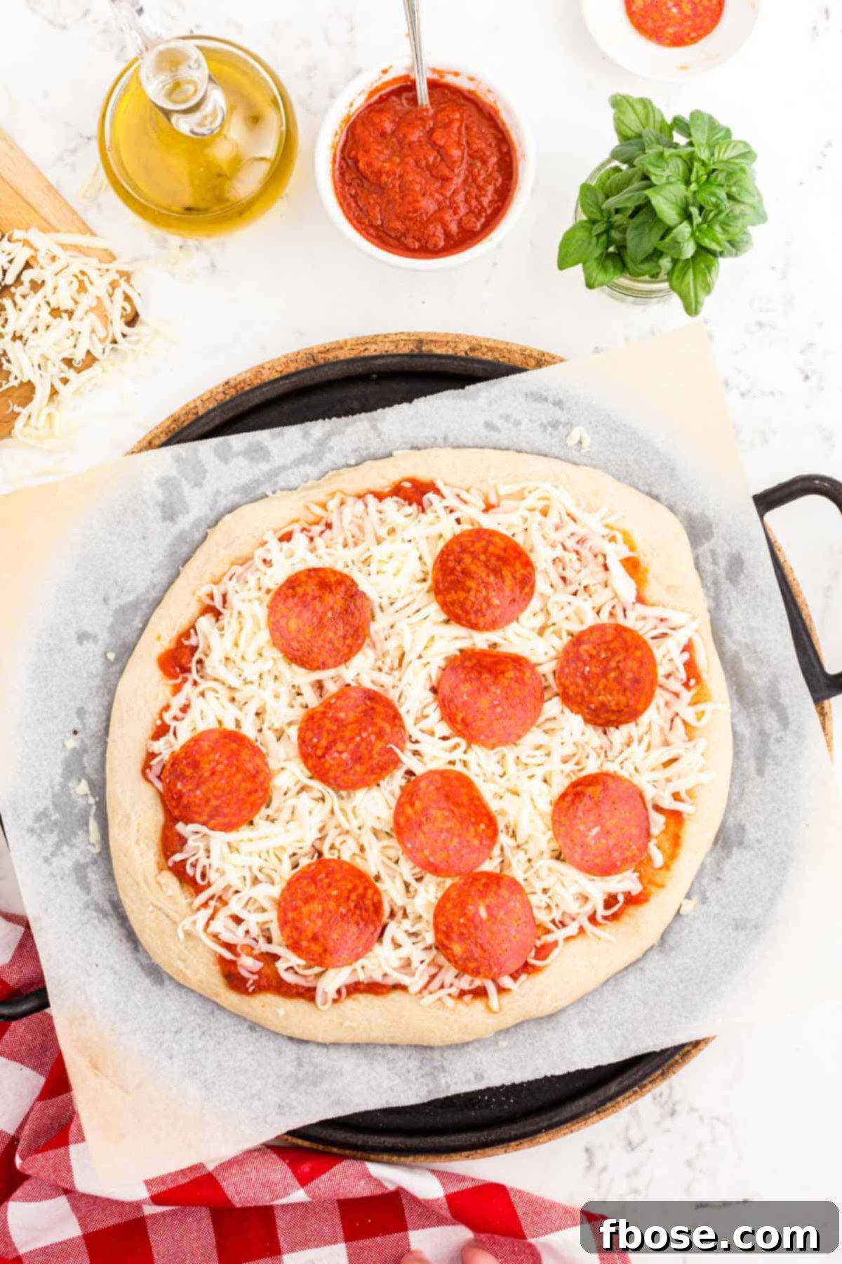 Perfect Sourdough Pizza Dough 16 A beautifully prepared sourdough pizza, topped with vibrant sauce, melted cheese, and fresh ingredients, ready to be baked in the oven.