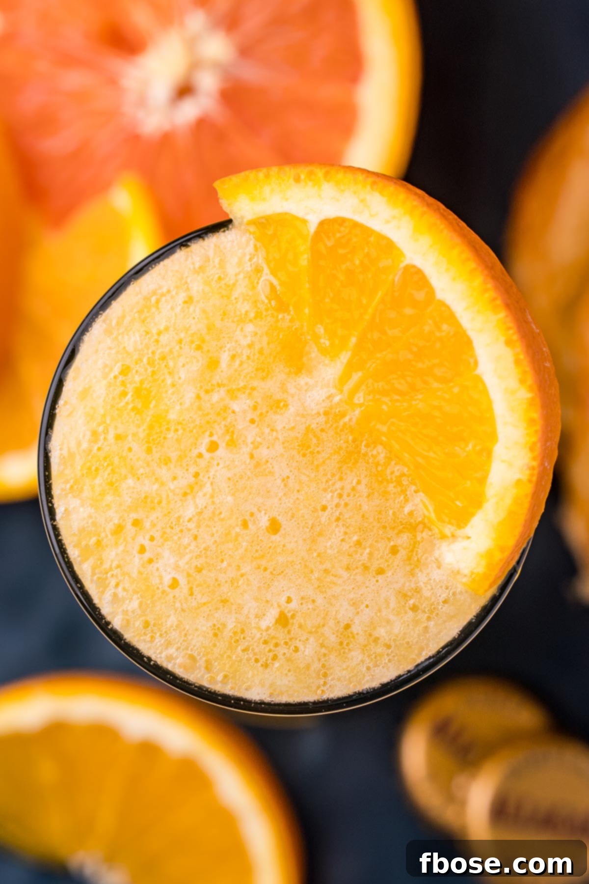 Overhead photo of a beermosa topped with a slice of orange, showcasing its vibrant color and inviting presentation.
