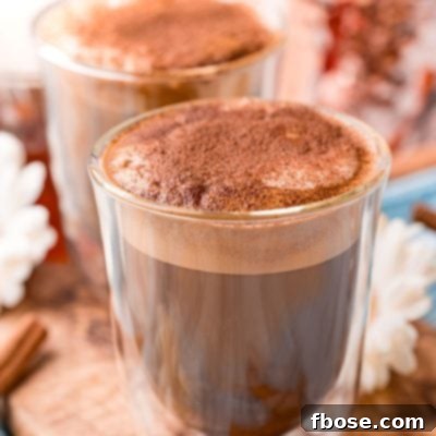 Close up photo of a double walled coffee glass filling with cafe con miel.