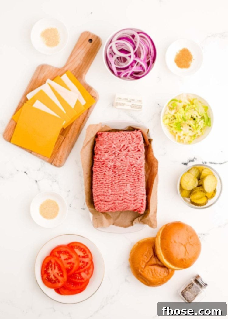 Ingredients to make homemade smash burgers prepped on a marble surface.