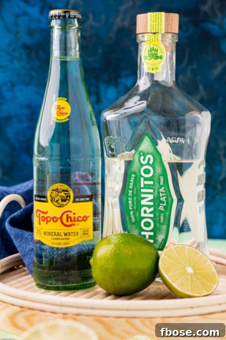 Ingredients used to make Ranch Water on a wicker tray with a blue background.