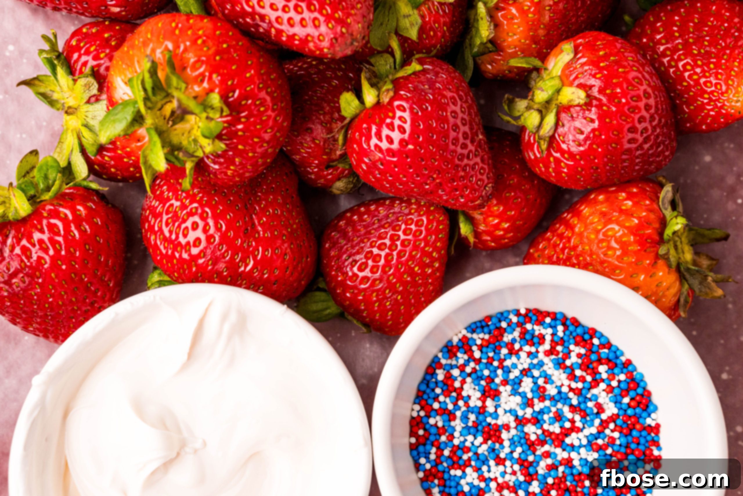 Independence Day Strawberry Delights 4 Ingredients to make 4th of july strawberries close together on a table.