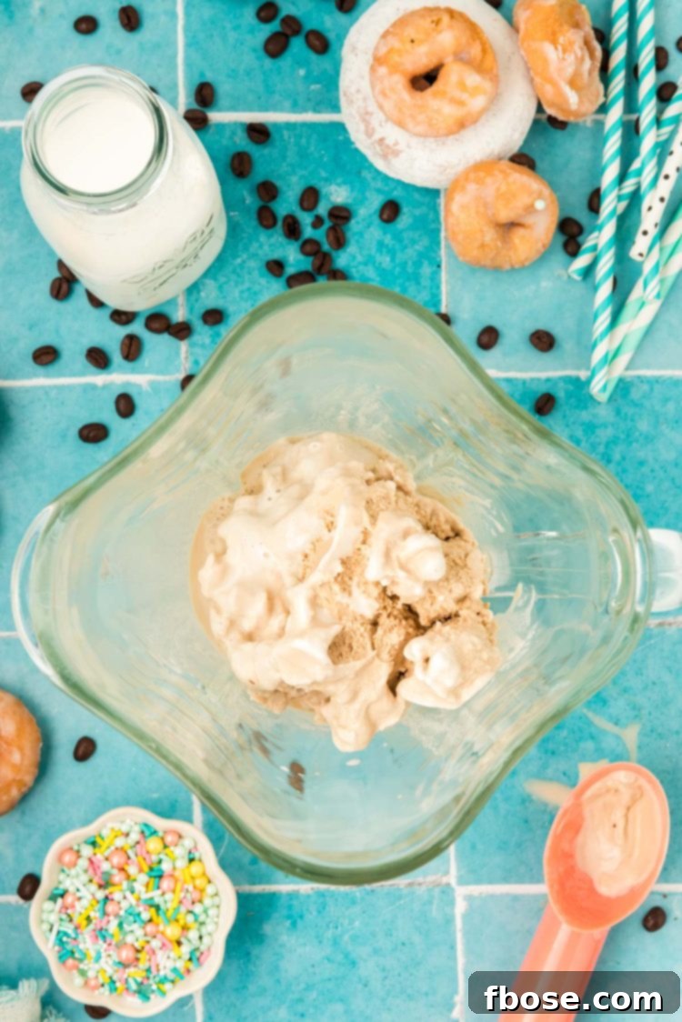 Ingredients to make a coffee milkshake in a blender.