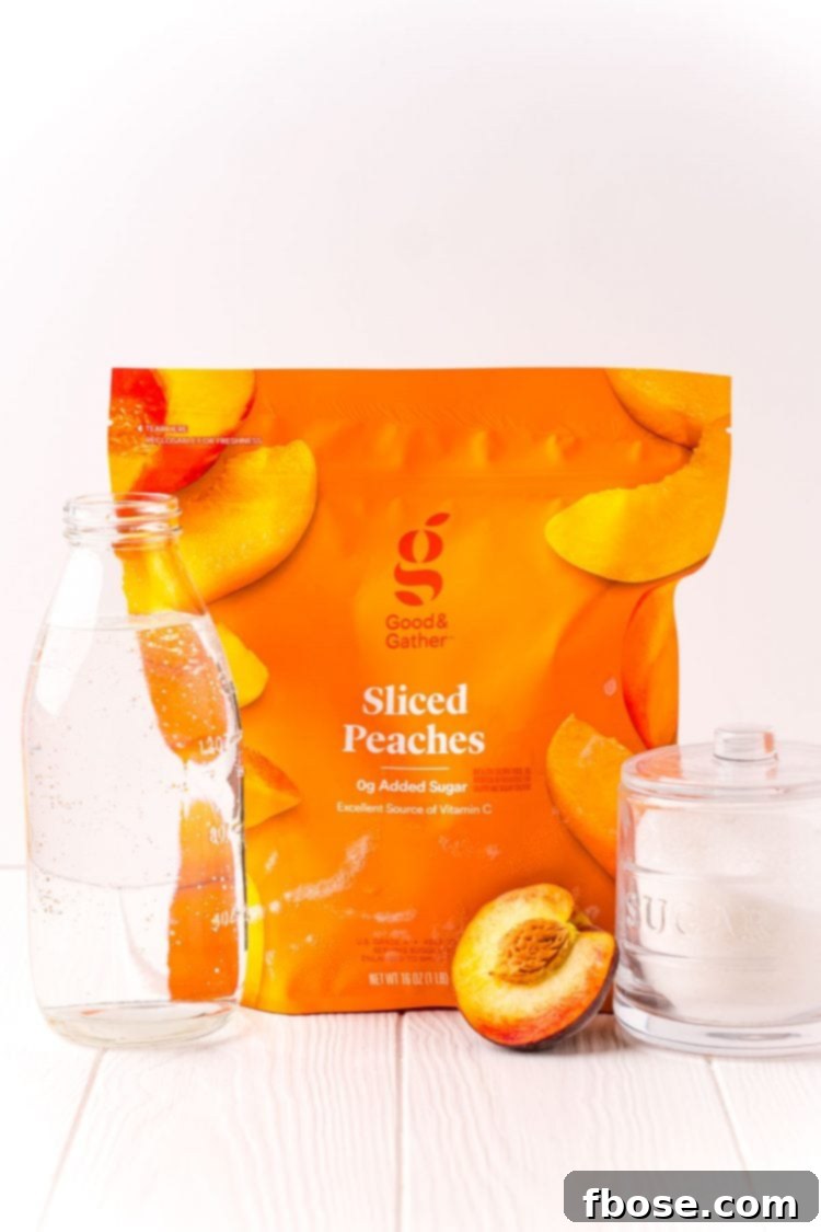 Ingredients used to make peach simple syrup on a white backdrop.