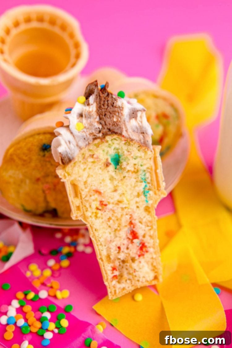 A cupcakes baked into an ice cream cone shown cut in half to reveal the inside.