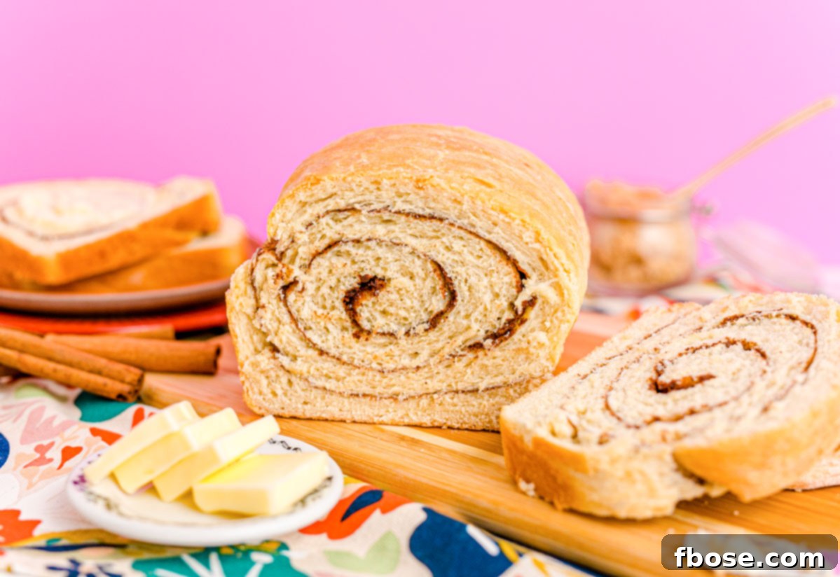 Close up photo of a loaf of cinnamon swirl bread that has been sliced into revealing the center.