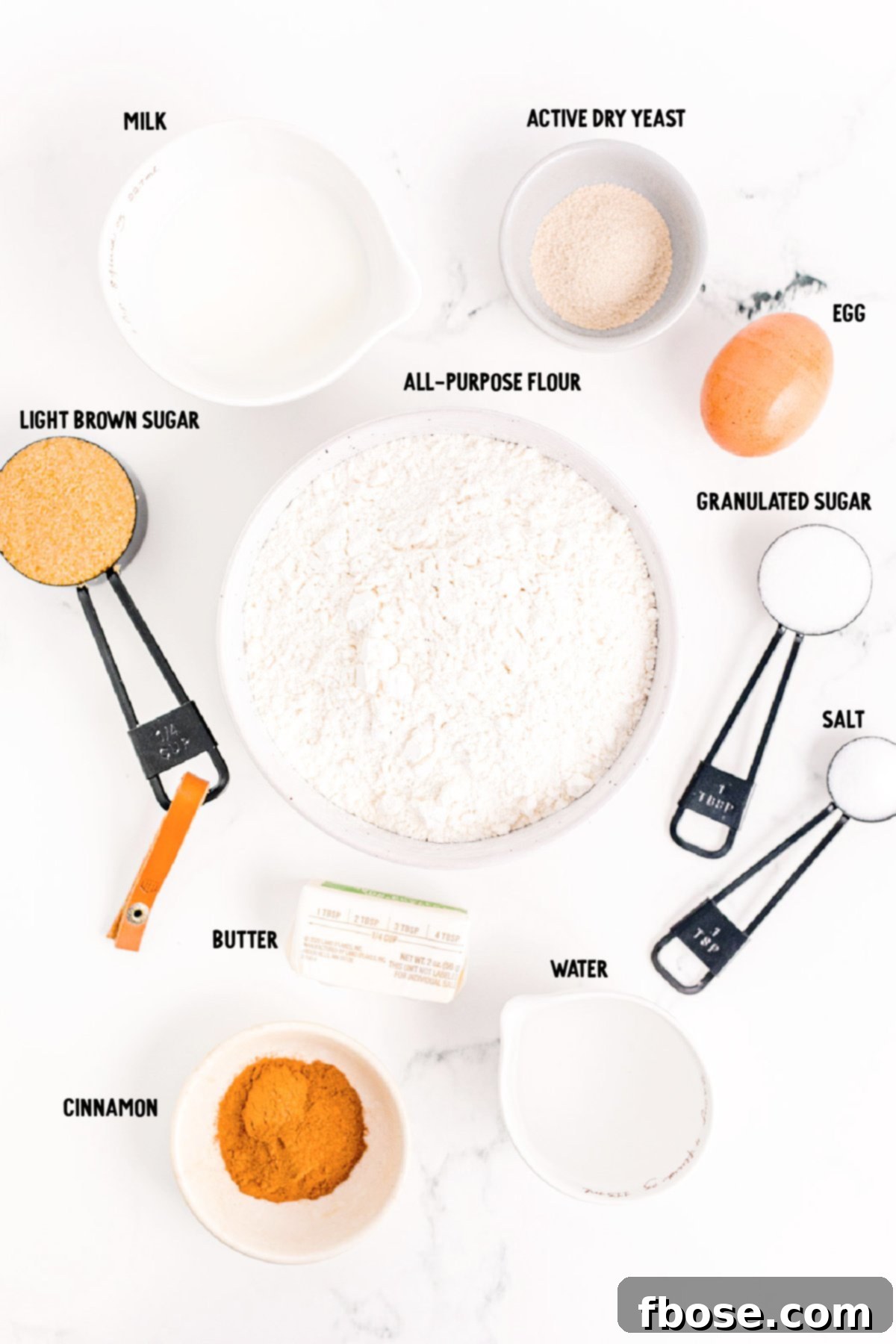 Overhead photo of ingredients to make cinnamon swirl bread prepped on a marble surface.