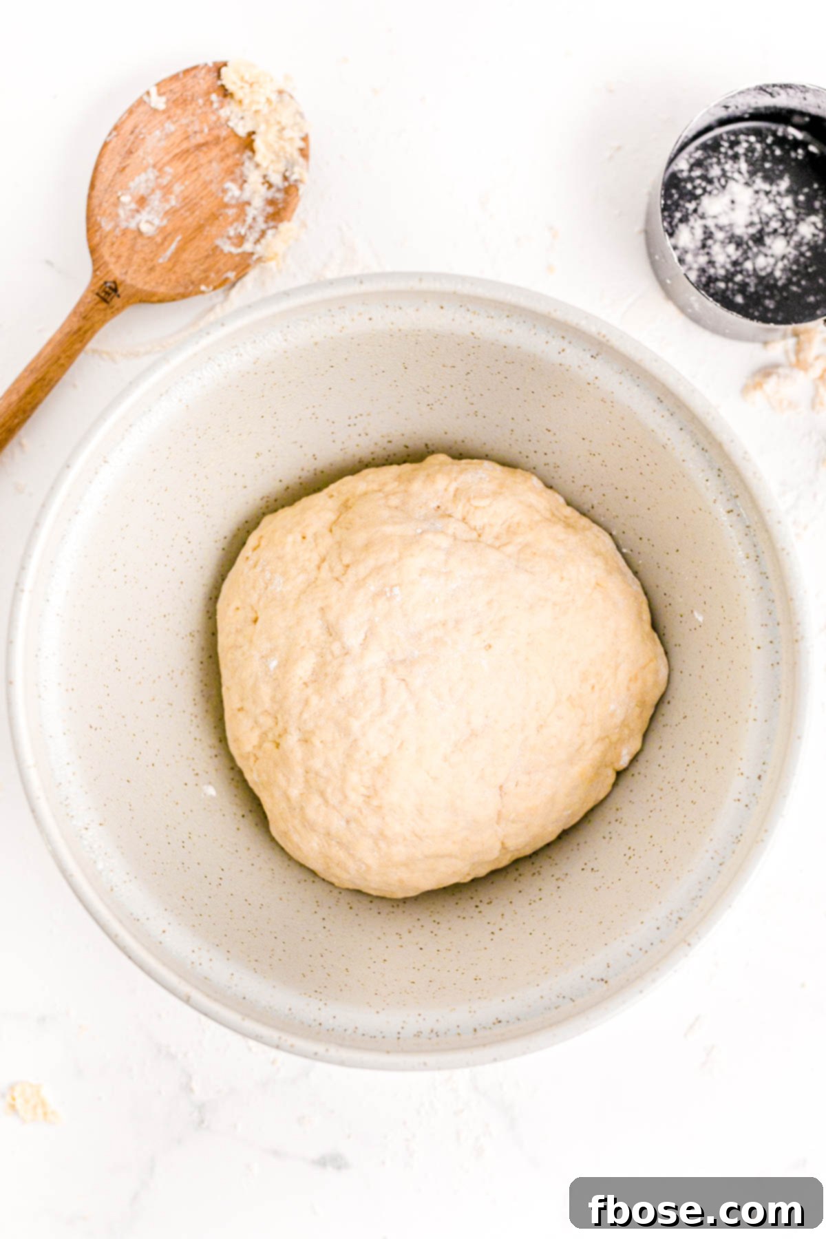 Bread dough in a ball in a bowl ready to proof.