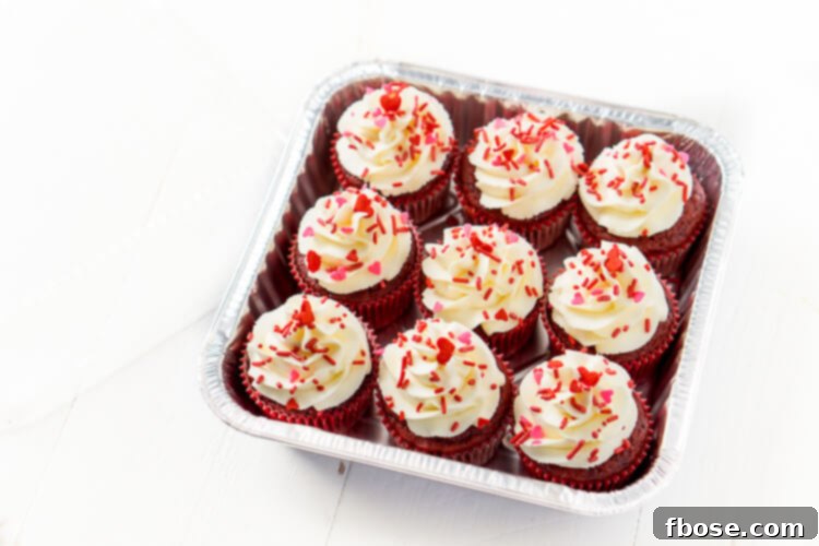 Effortless Red Velvet: Only 5 Ingredients 2 Nine Red Velvet Cupcakes neatly arranged in a disposable aluminum baking tin with a clear dome lid.