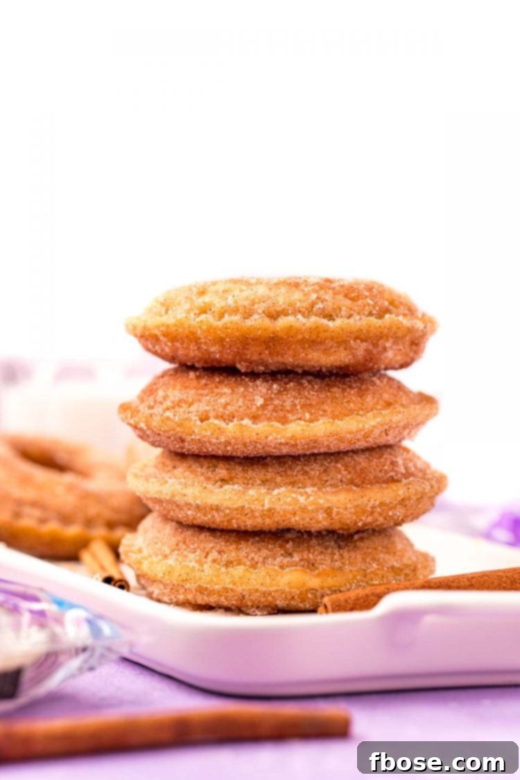 Viral Uncrustables Donut Hack 3 4 uncrustables donuts stacked on top of each other on a white serving tray on a purple surface.
