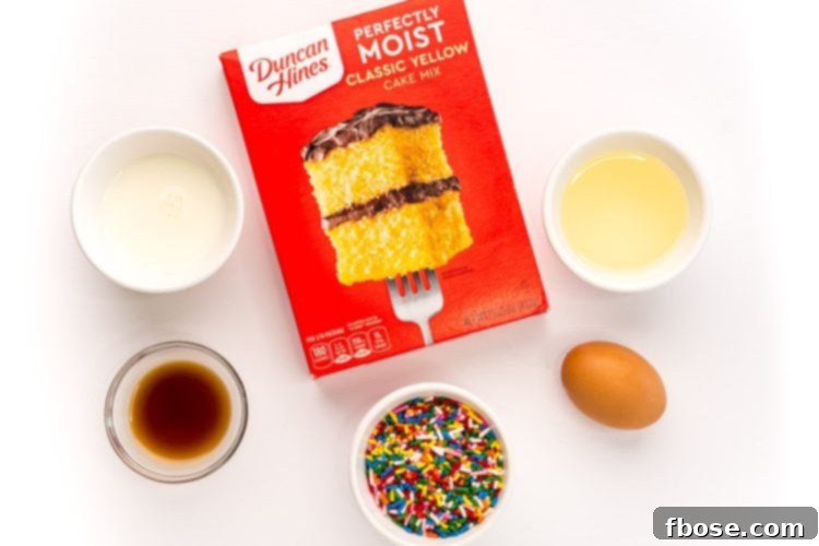 Ingredients to make cake batter blondies on a white table.