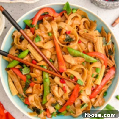 Overhead photo of a blue bowl filled with drunken noodles.