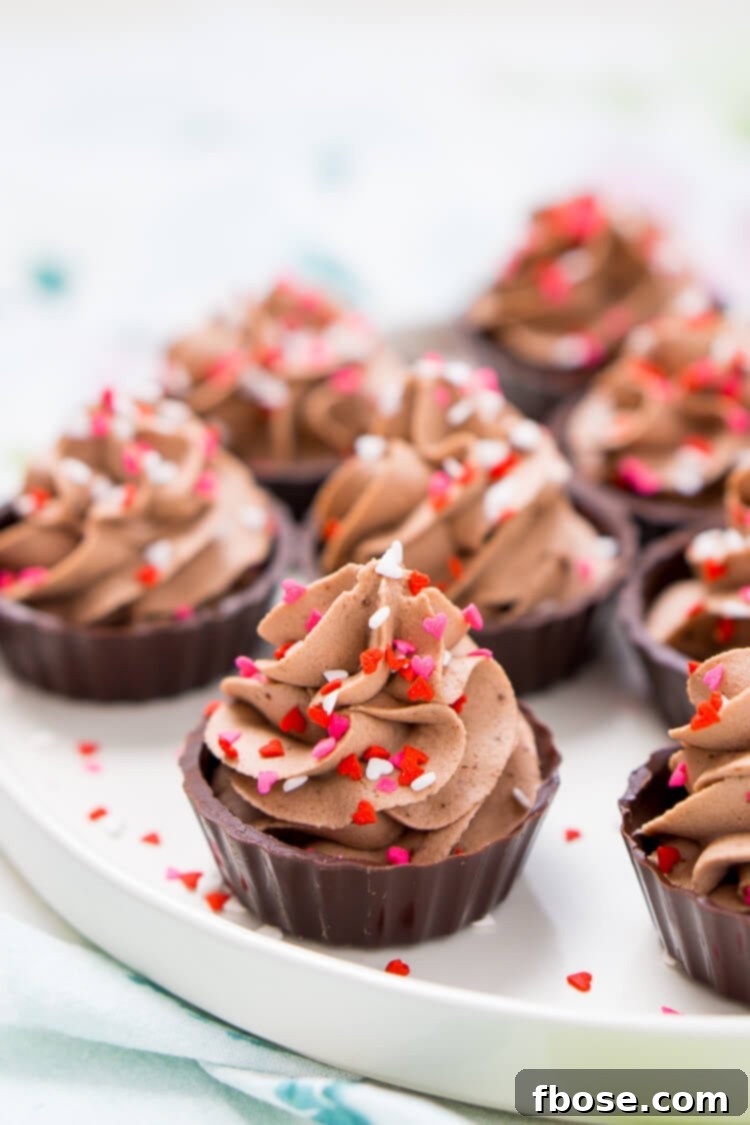 Decadent Four Ingredient Chocolate Mousse Cups 8 Hand holding a 4-Ingredient Chocolate Mousse Cup, emphasizing personal enjoyment and a moment of indulgence.