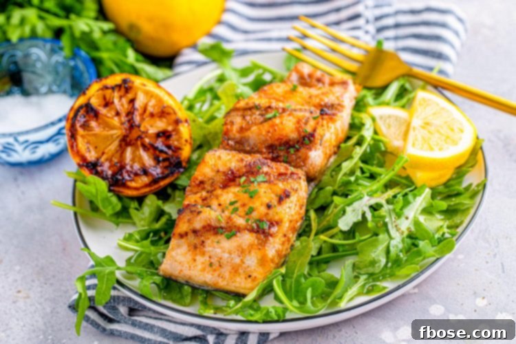 Grilled mahi mahi on a bed of greens.