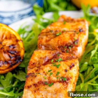 Close up photo of grilled mahi mahi on a bed of greens.