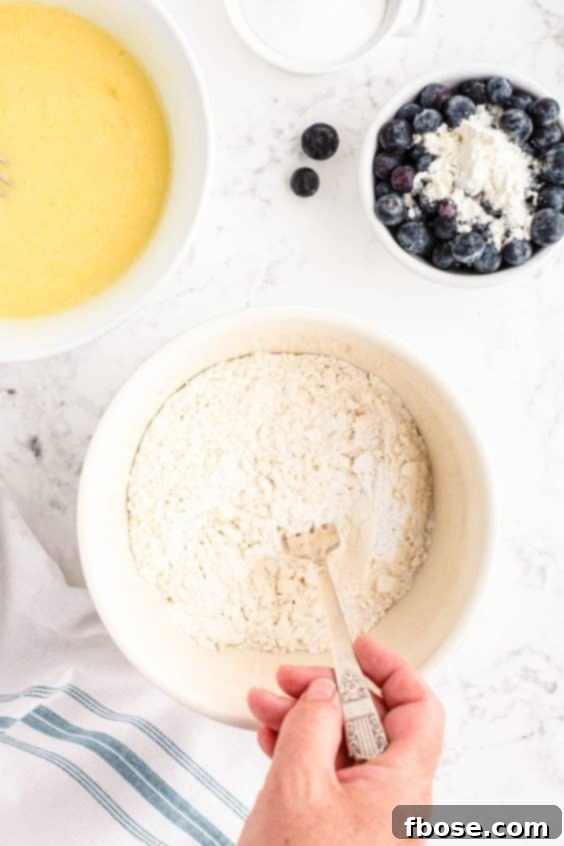 Dry ingredients being mixed with a fork in a bowl.