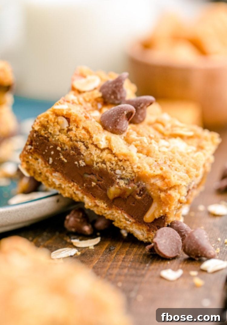 Easy Gooey Caramel Oatmeal Bars 3 Close up photo of a carmelita leaning on a teal plate on a wood table, showing the layered texture.