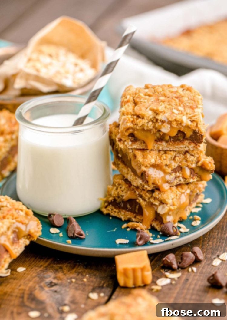 Easy Gooey Caramel Oatmeal Bars 6 Carmelitas stacked on a teal plate with a glass of milk on a wooden table, ready to be enjoyed.