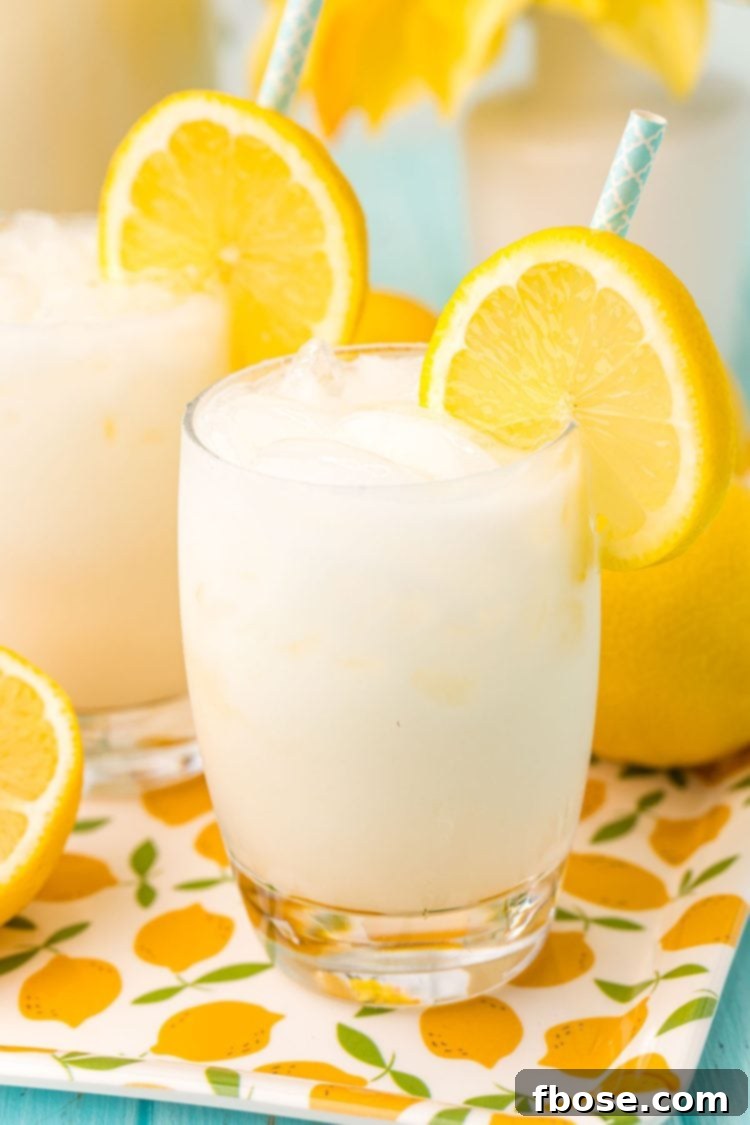 Close up photo of a glass filled with ice and creamy lemonade.