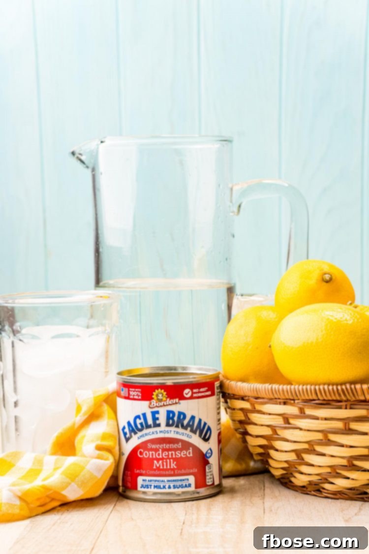 Ingredients to make creamy lemonade on a wooden counter.