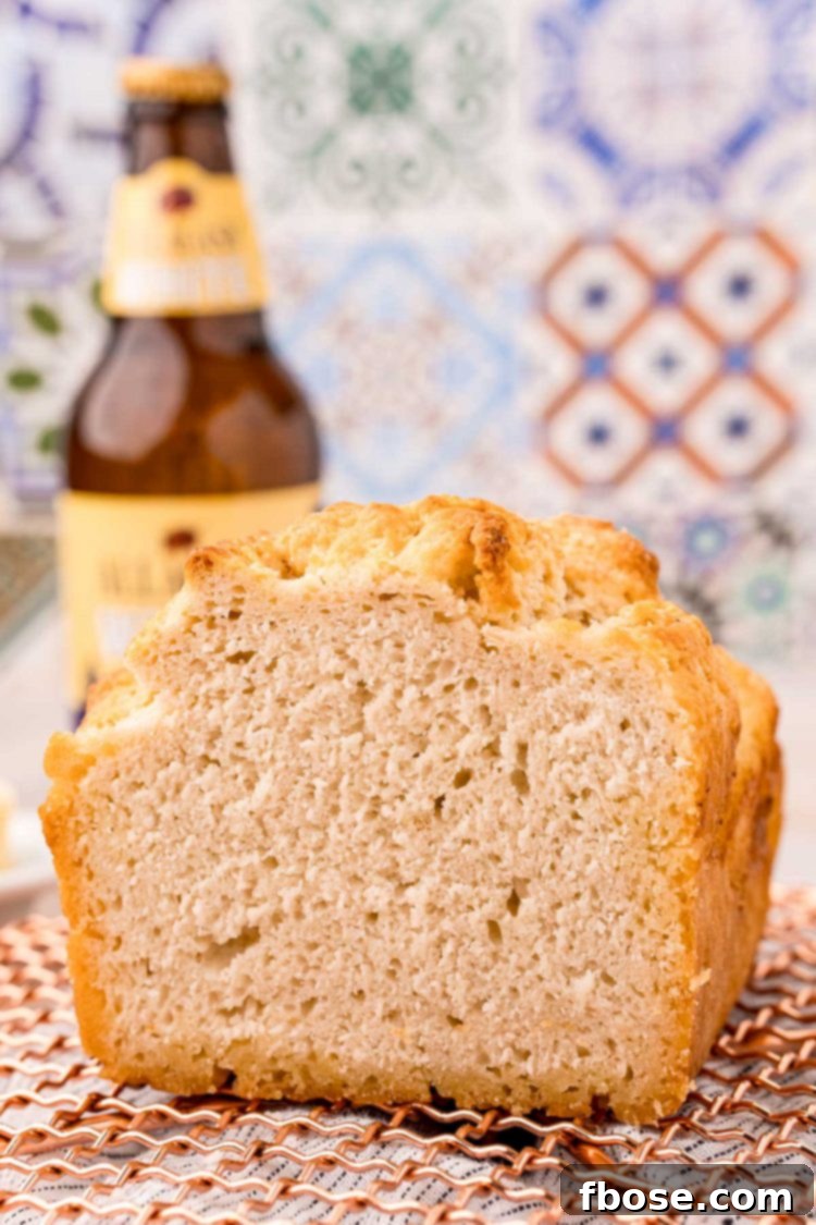 Simple & Delicious Beer Bread 3 Close up photo of a loaf of beer bread that has been sliced.