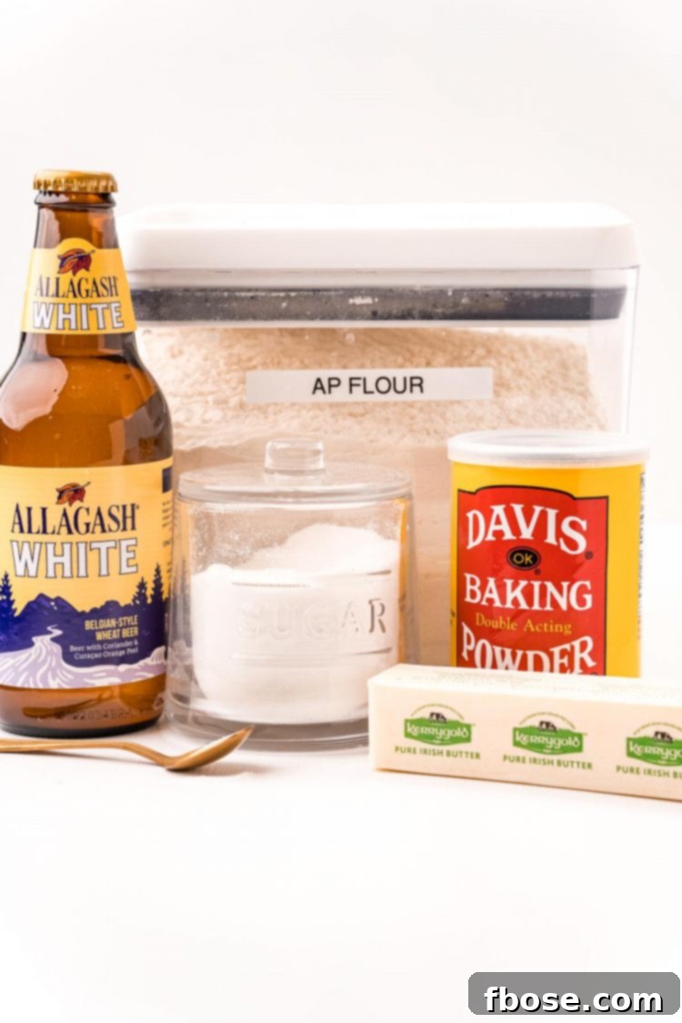 Simple & Delicious Beer Bread 4 Ingredients to make beer bread on a white table.
