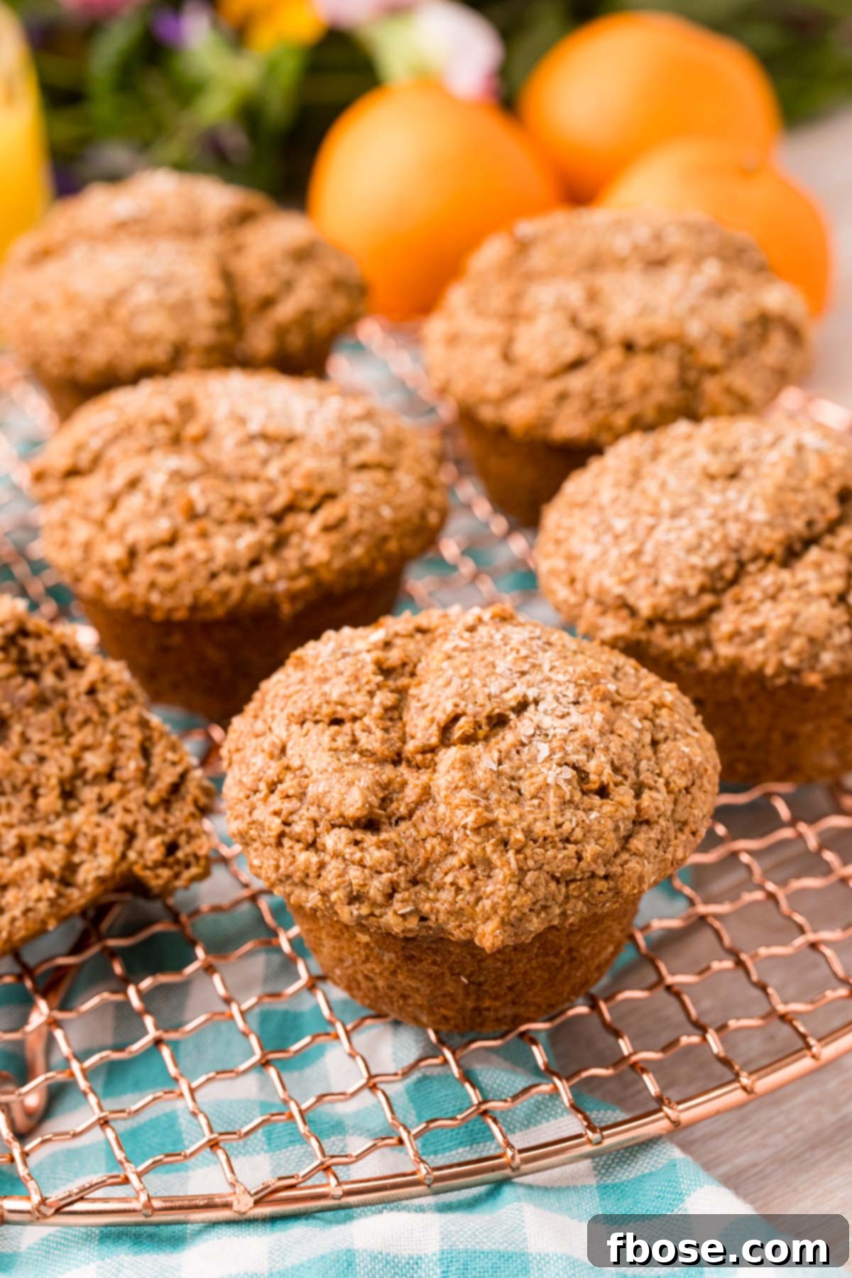 Bran muffins on a copper wire rack.