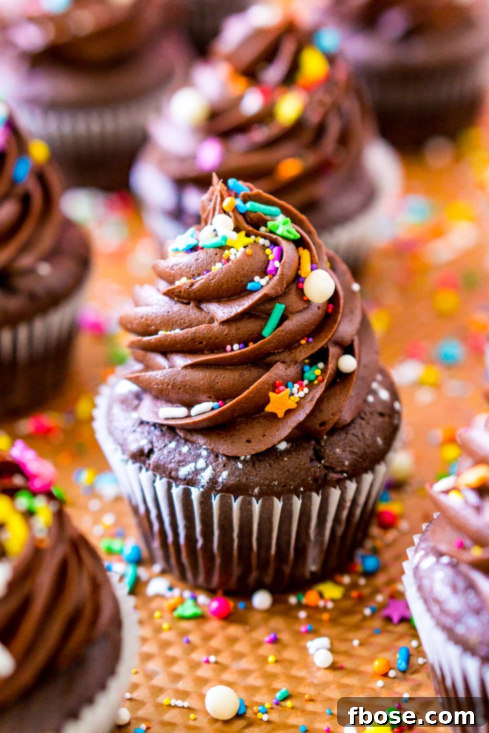 A close-up view of perfectly baked Chocolate Cupcakes, showcasing their rich texture and potential for delicious frosting, displayed on a copper baking sheet.