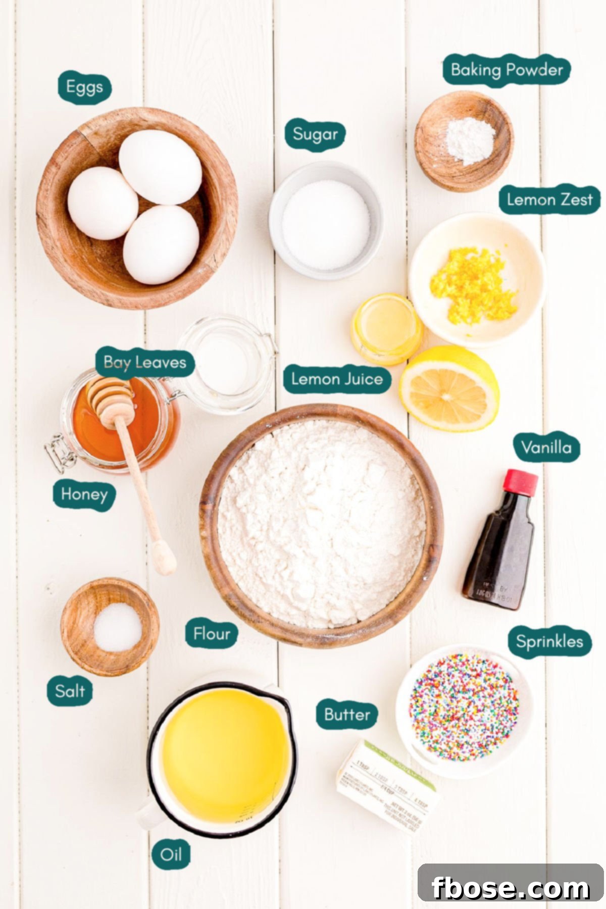 Classic Italian Struffoli 4 Overhead photo of ingredients to make struffoli on a white wooden table.