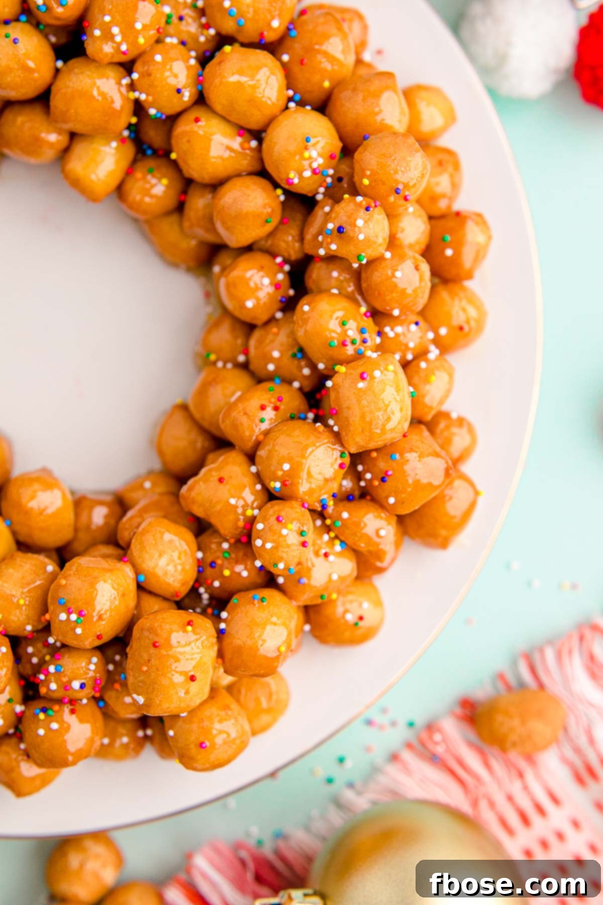 Classic Italian Struffoli 6 Close up photo of struffoli on a white plate.